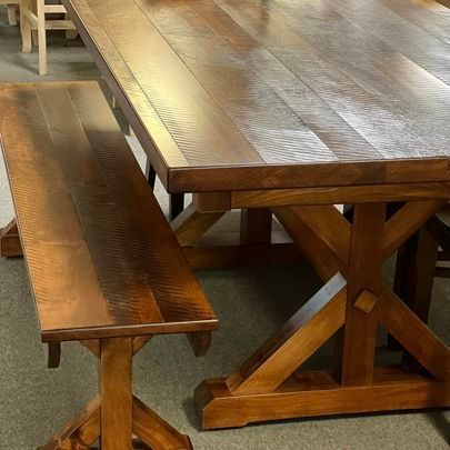 A wooden table with a bench next to it.