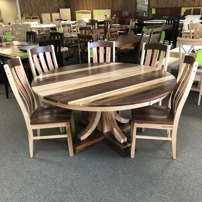 A wooden table and chairs are sitting in a room.