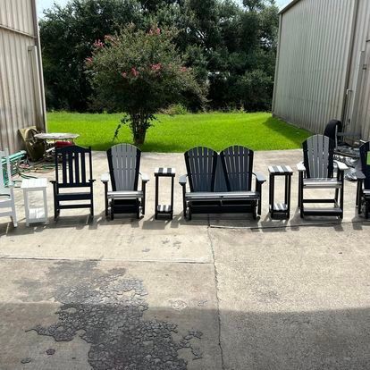 A row of chairs and tables are lined up in front of a building.