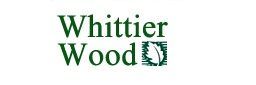 A logo for whittier wood is shown on a white background.