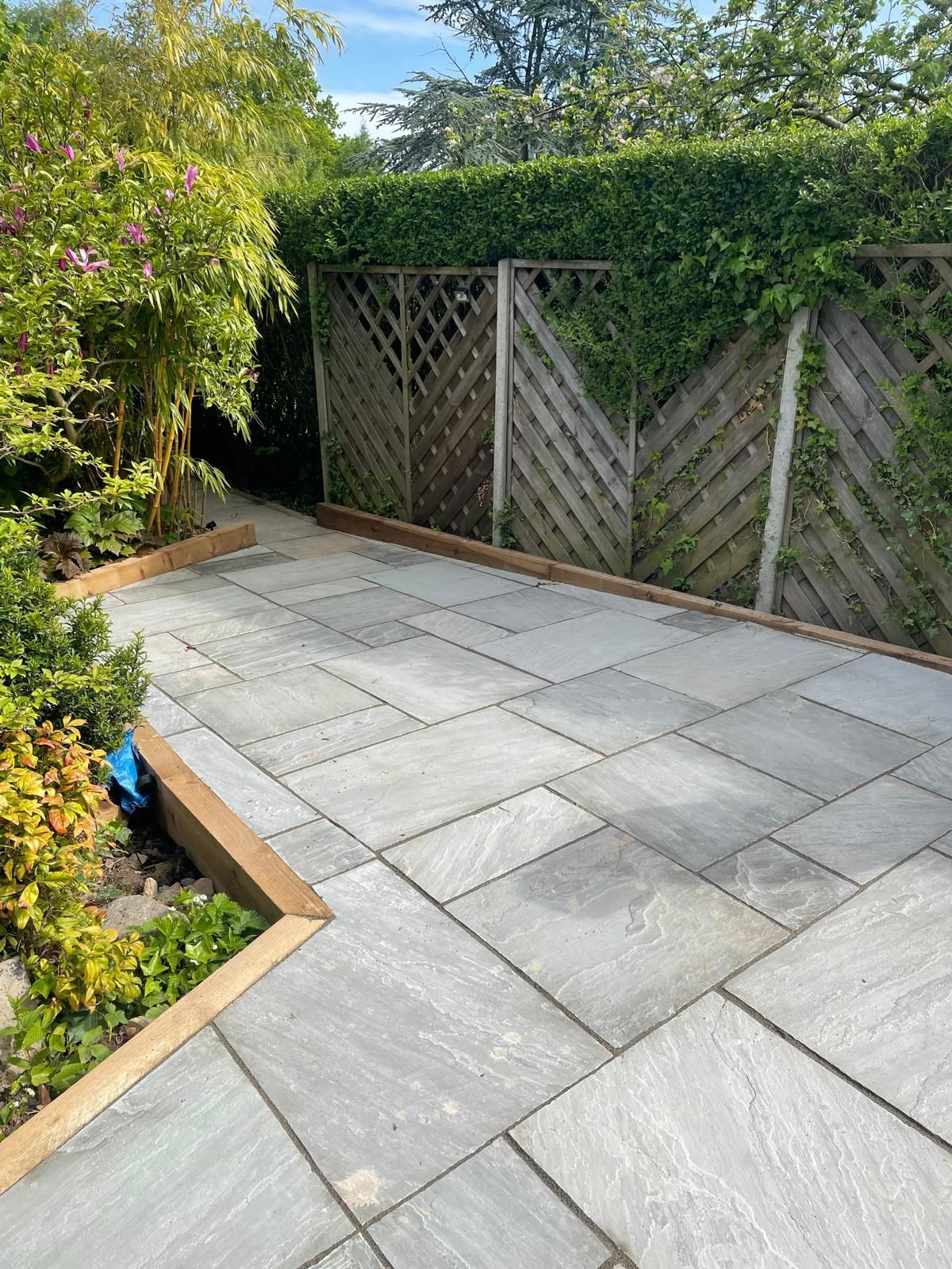 A patio with a wooden fence in the background.