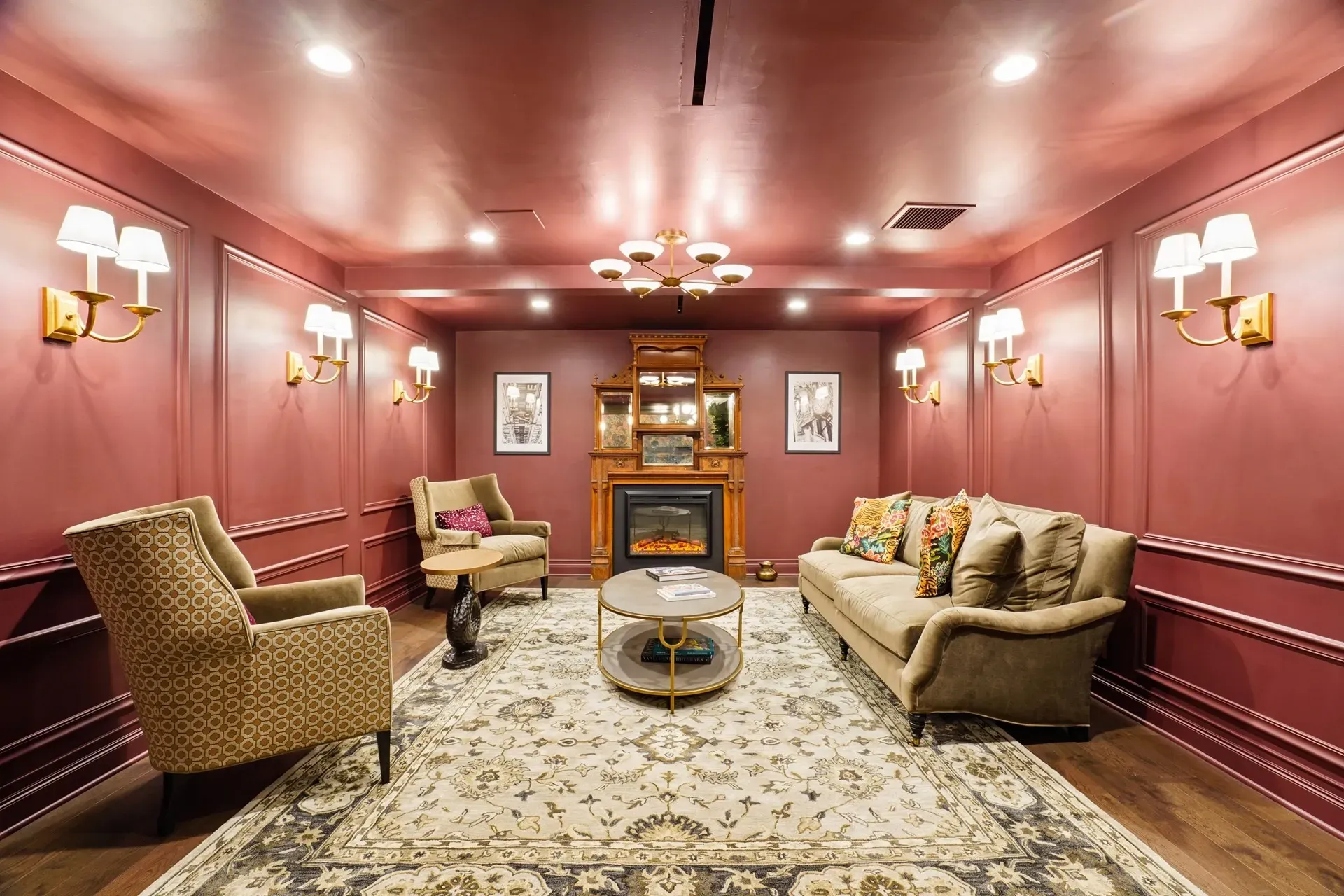 Elegant lounge area with a fireplace, comfortable seating, and decorative sconces.
