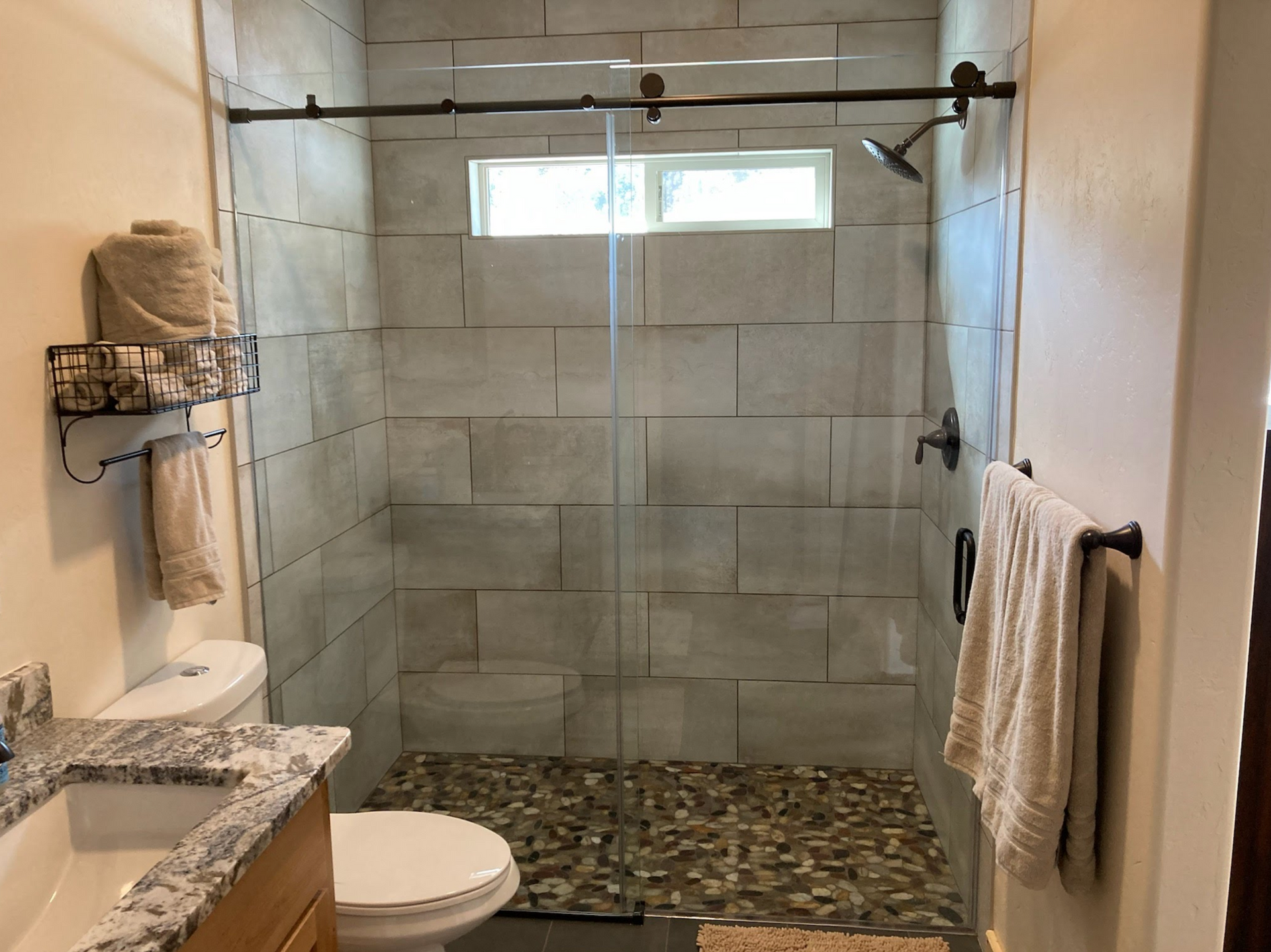 a picture of a shower, sliding shower glass door is from Sunglass