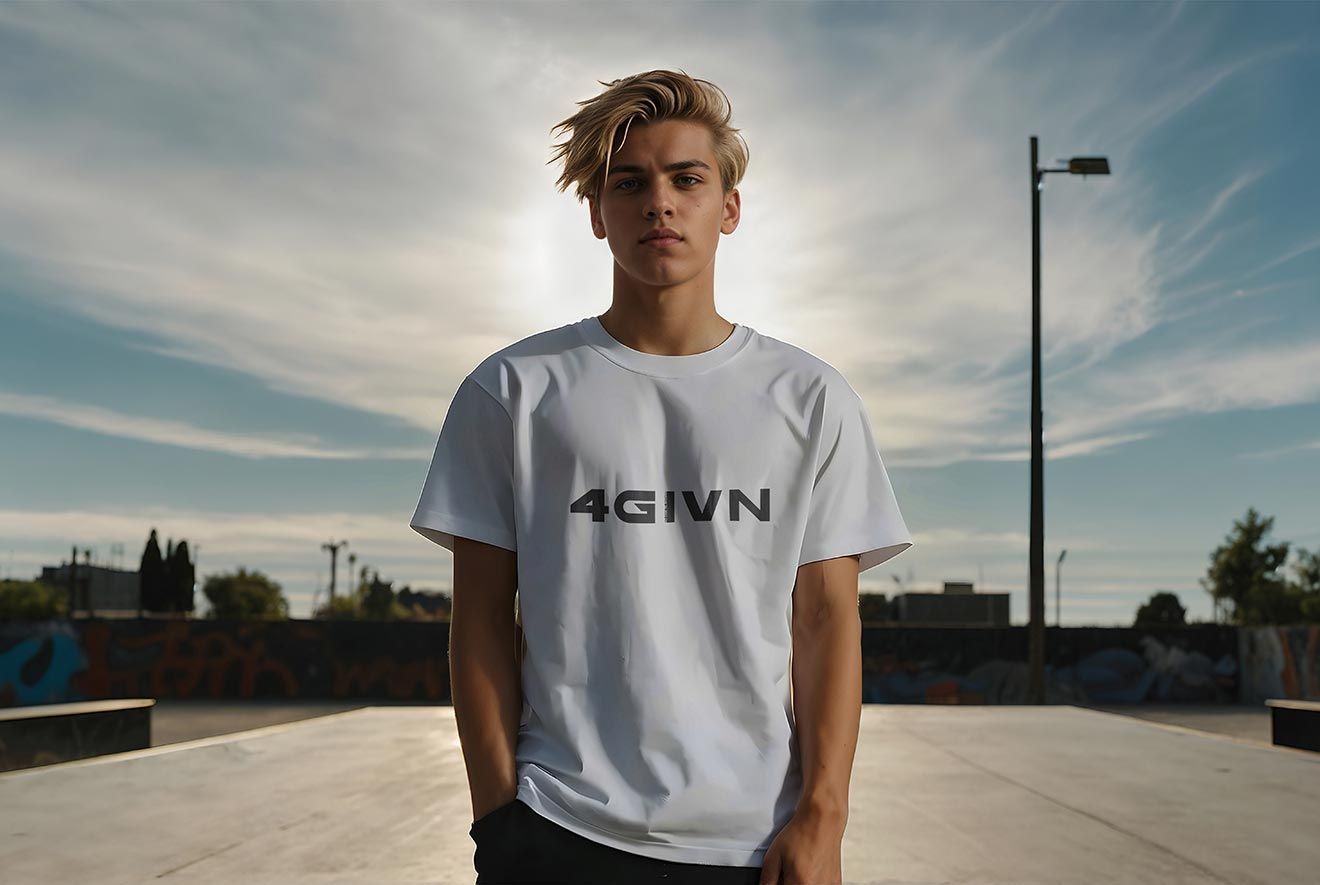 Young man with blonde hair, wearing a white t-shirt, stands in a skate park under a cloudy sky.