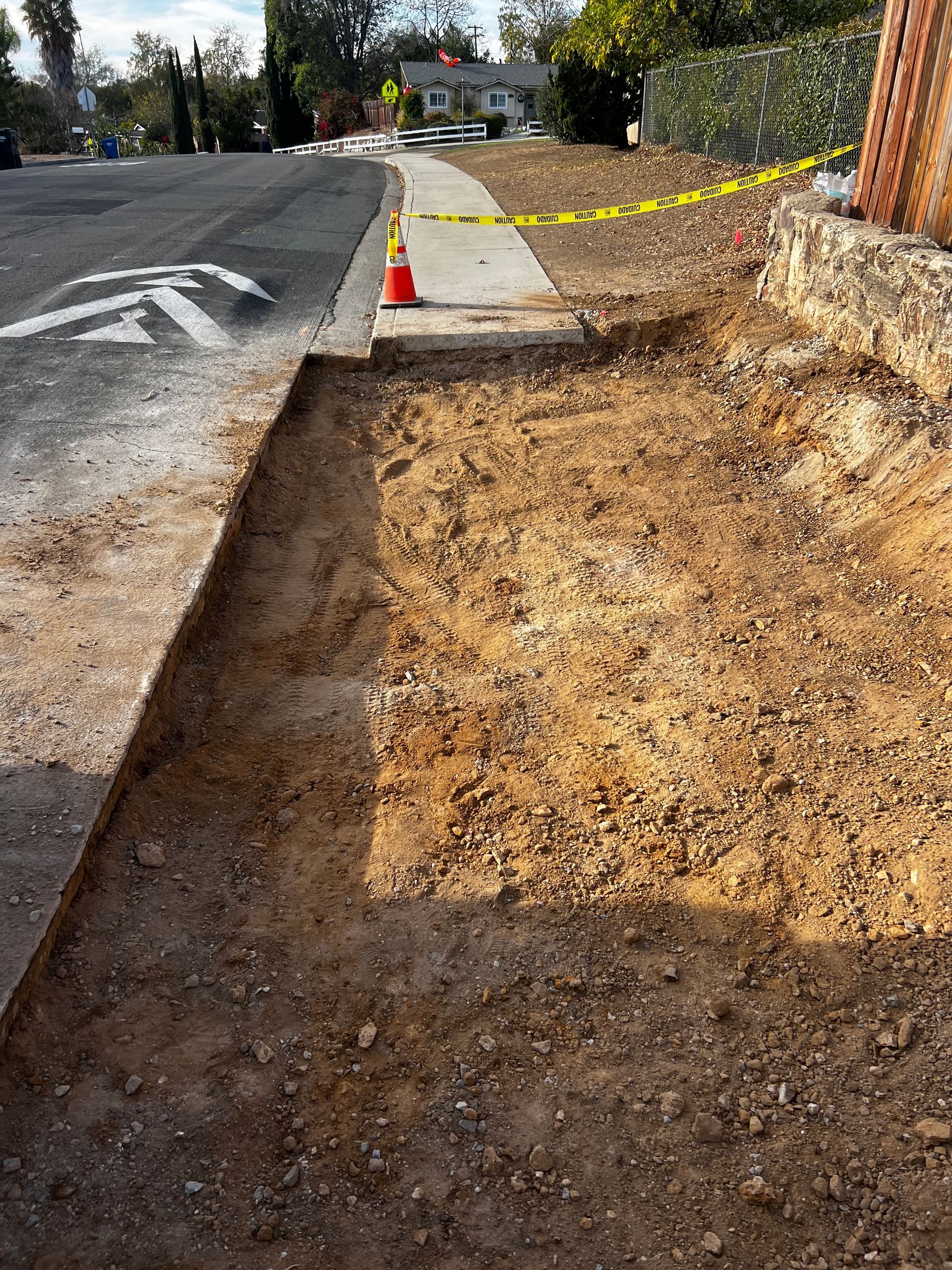 A sidewalk is being built on the side of a road.