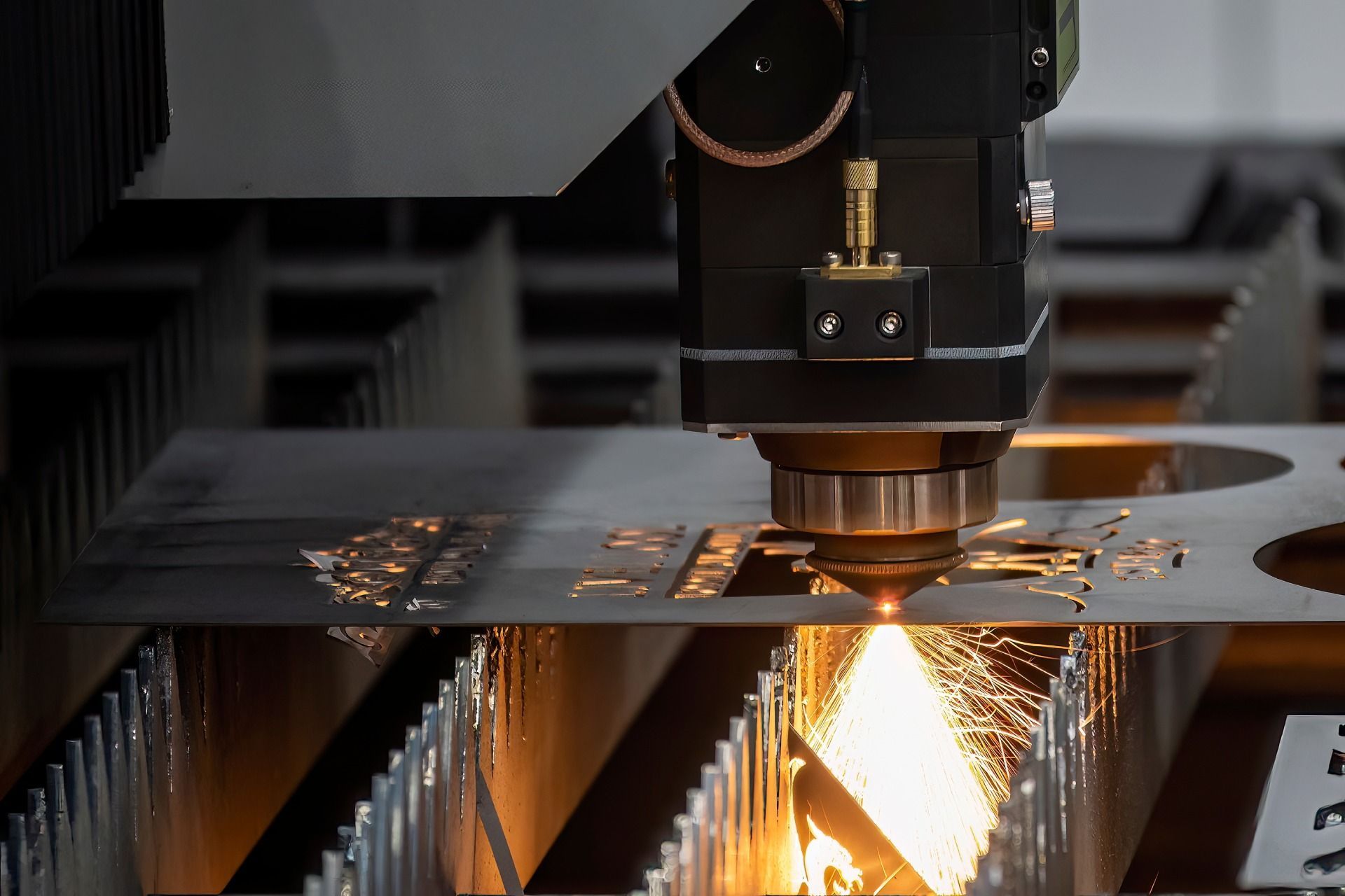 A machine is cutting a piece of metal in a factory.
