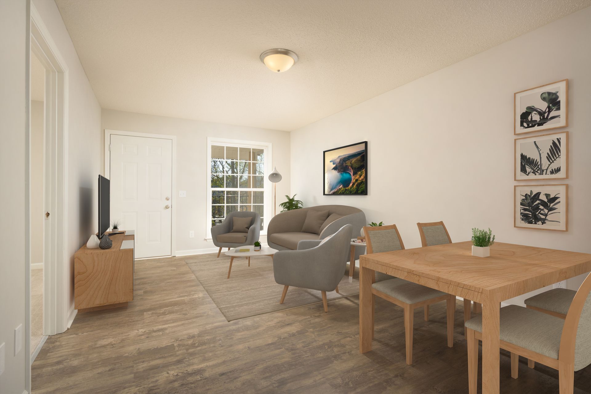 A modern apartment living room with a dining set, gray seating, light wood flooring, and framed art on a white wall.