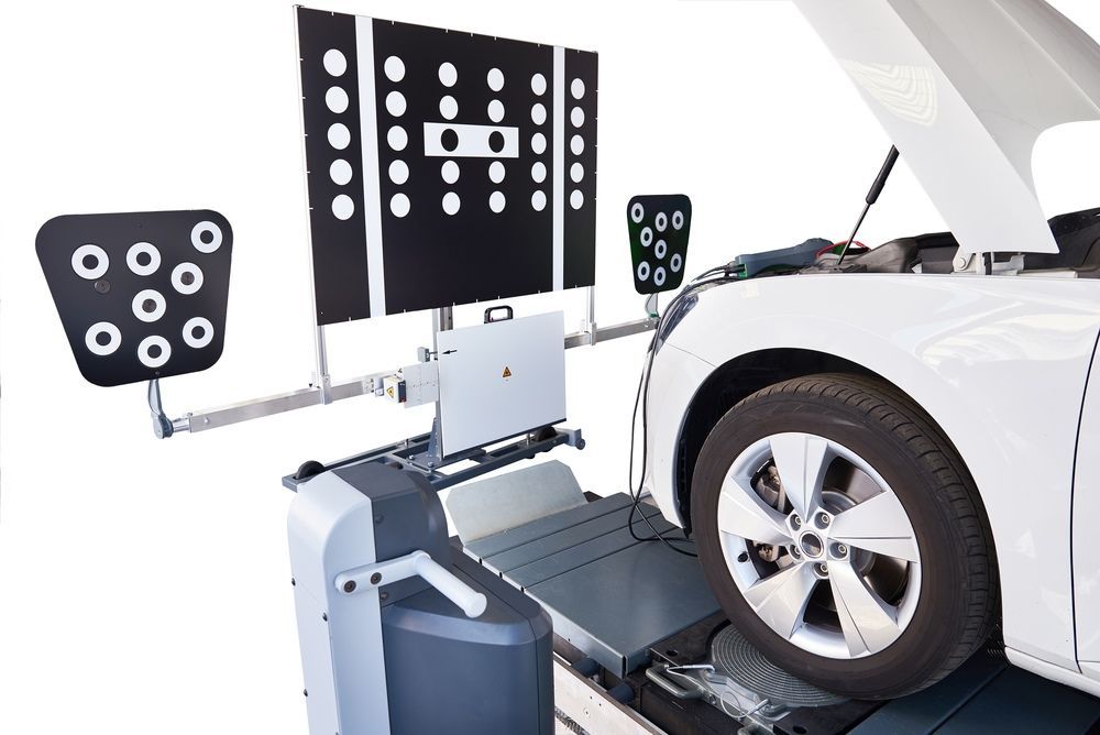 A White Car is Being Checked by a Machine With the Hood Open — Forster Mechanical Repairs & Servicing In Forster, NSW