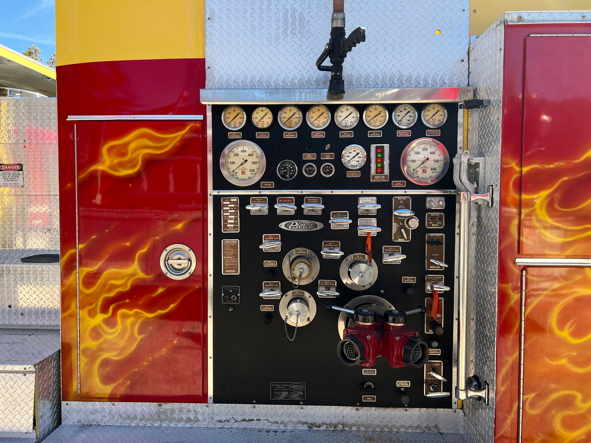 A fire truck with flames painted on the side