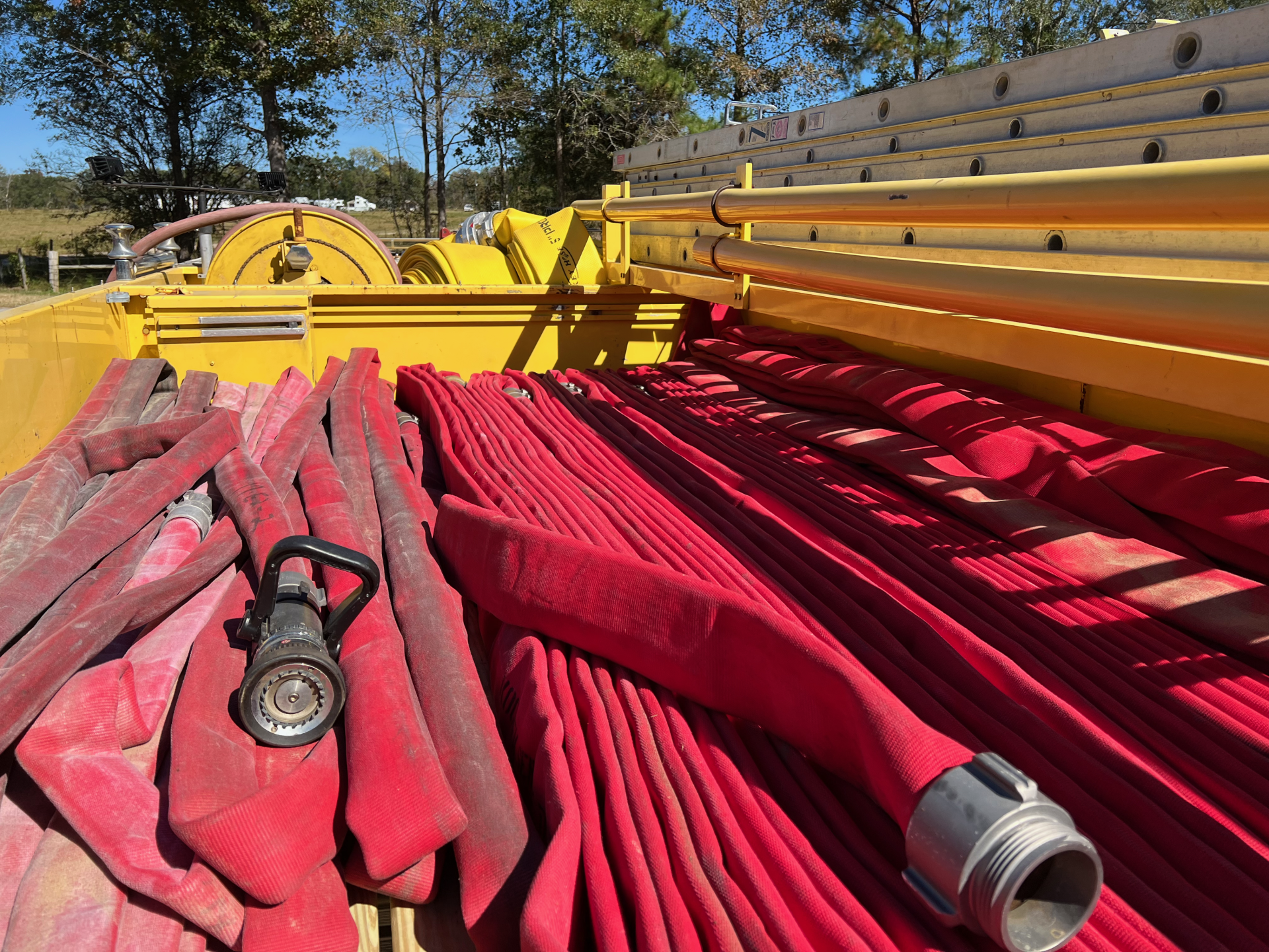 A bunch of red hoses are stacked on top of each other