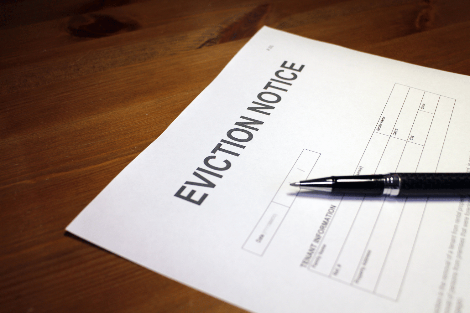 Eviction notice with a pen on a wooden desk