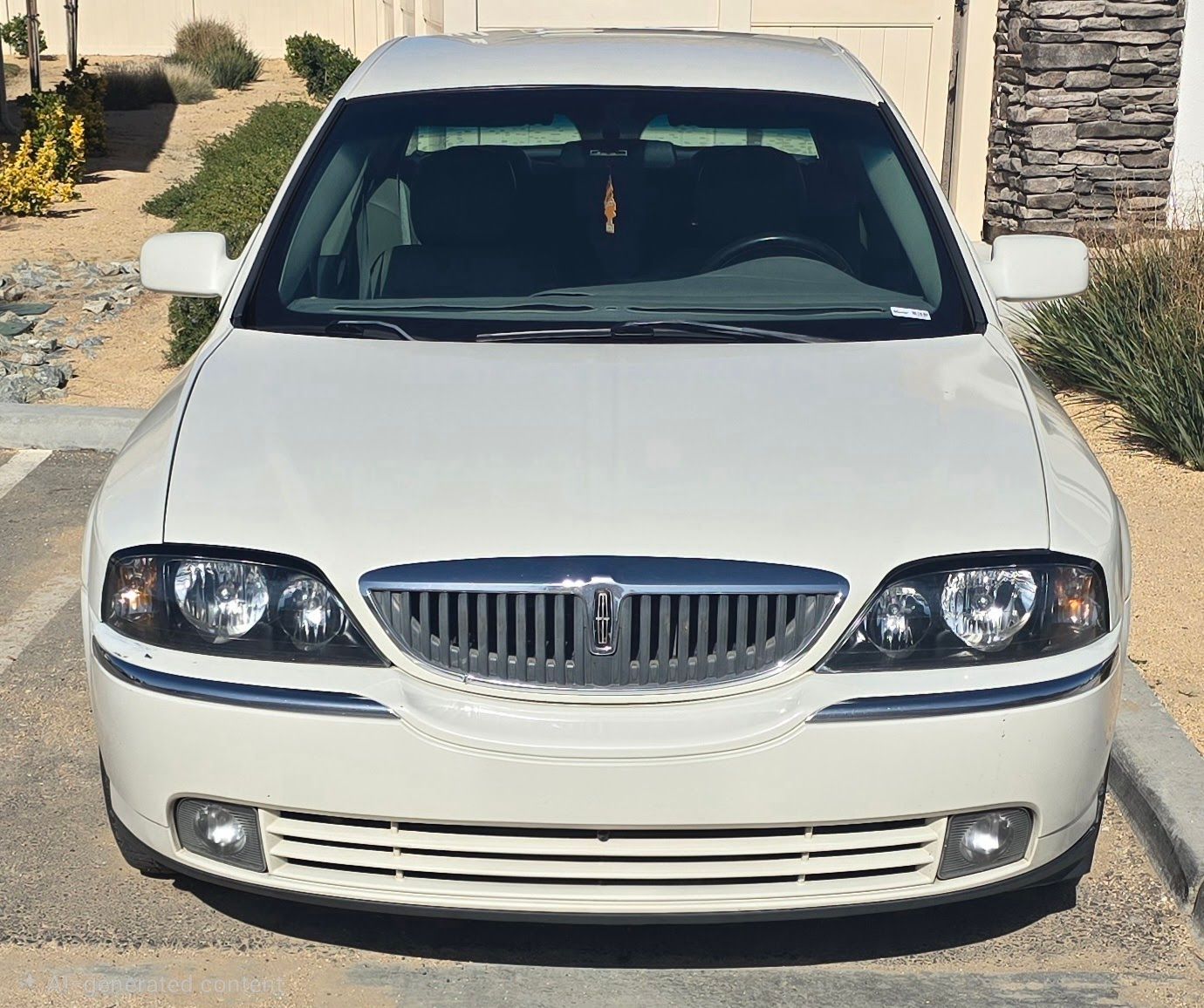Front view of a white sedan parked in a driveway