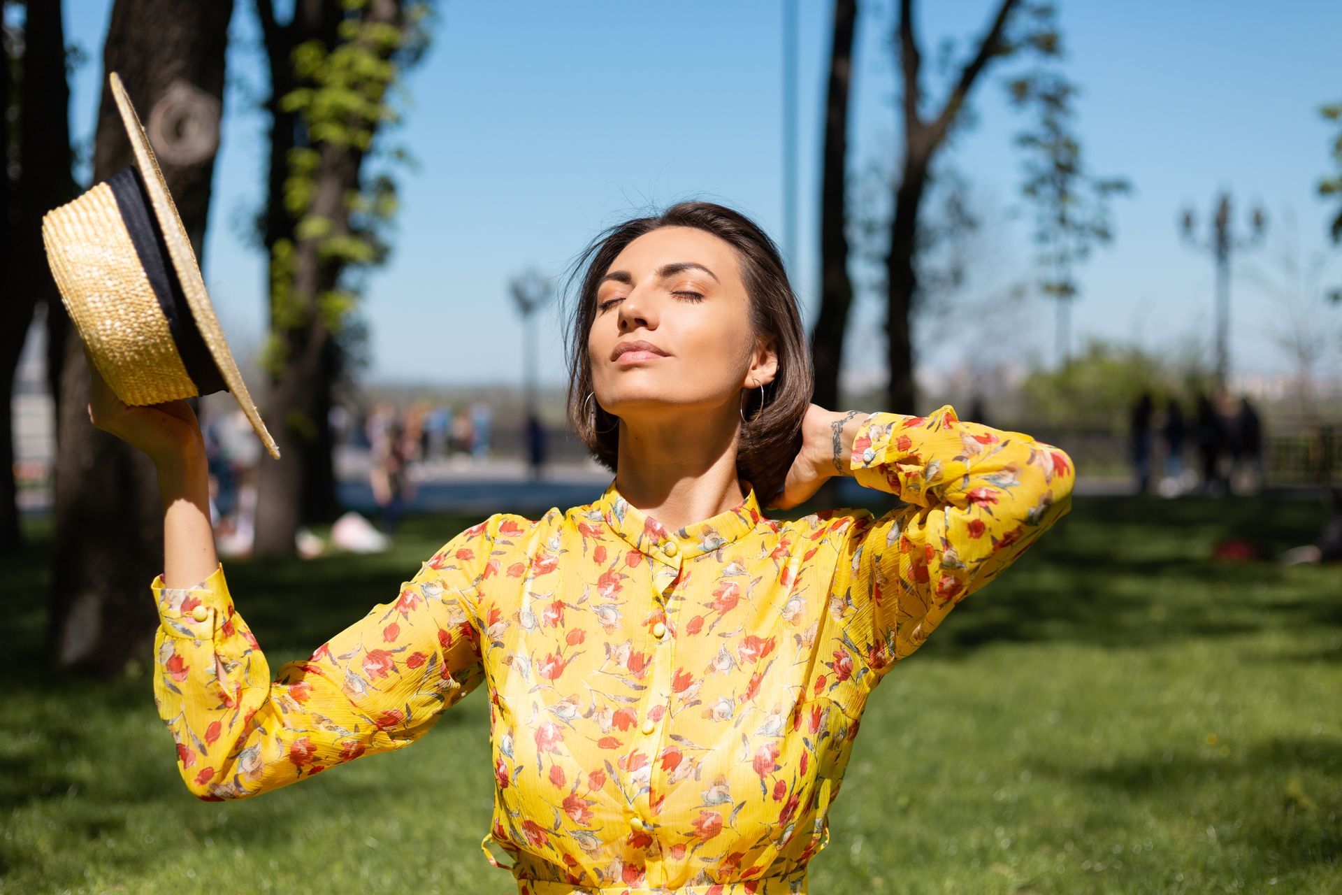 A woman enjoys the summer heat after finding relief from summer allergies.
