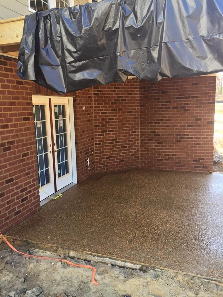 Covered brick patio with French doors and black tarp overhead
