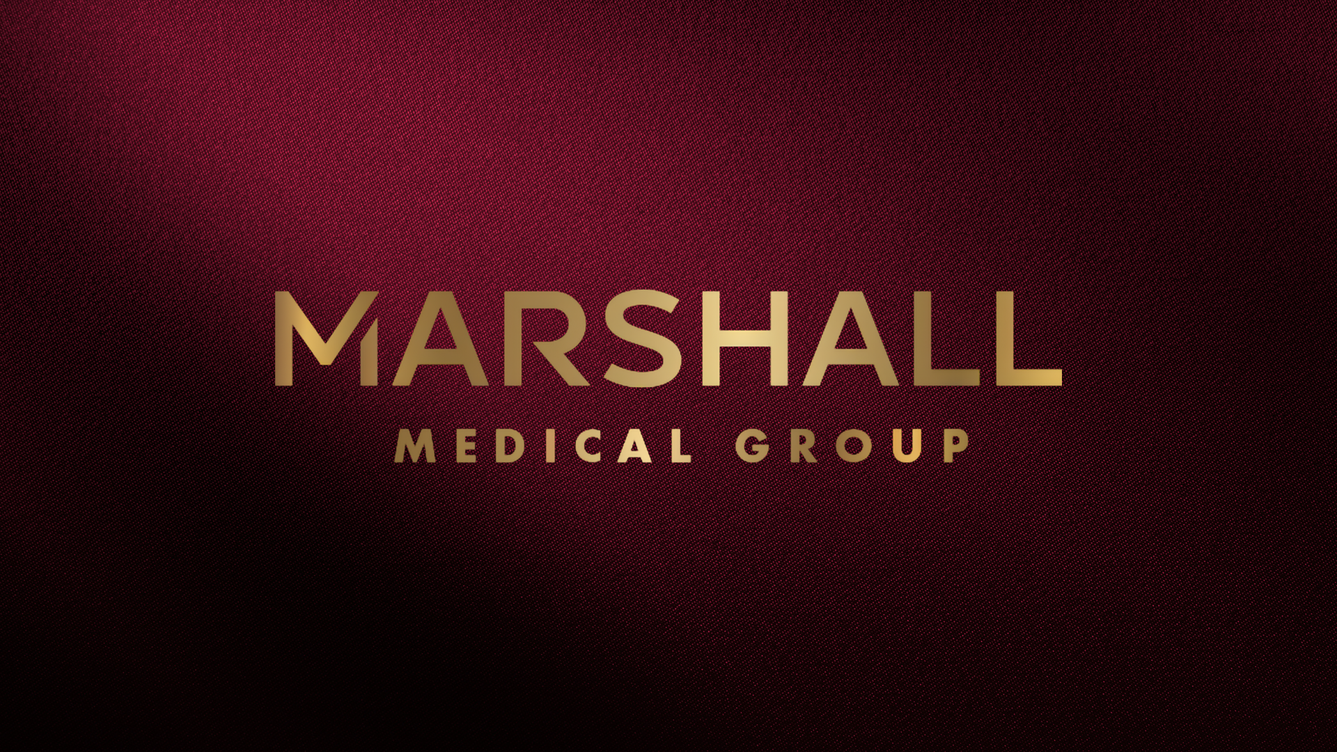 Marshall Medical Group logo in gold on a dark maroon textured background