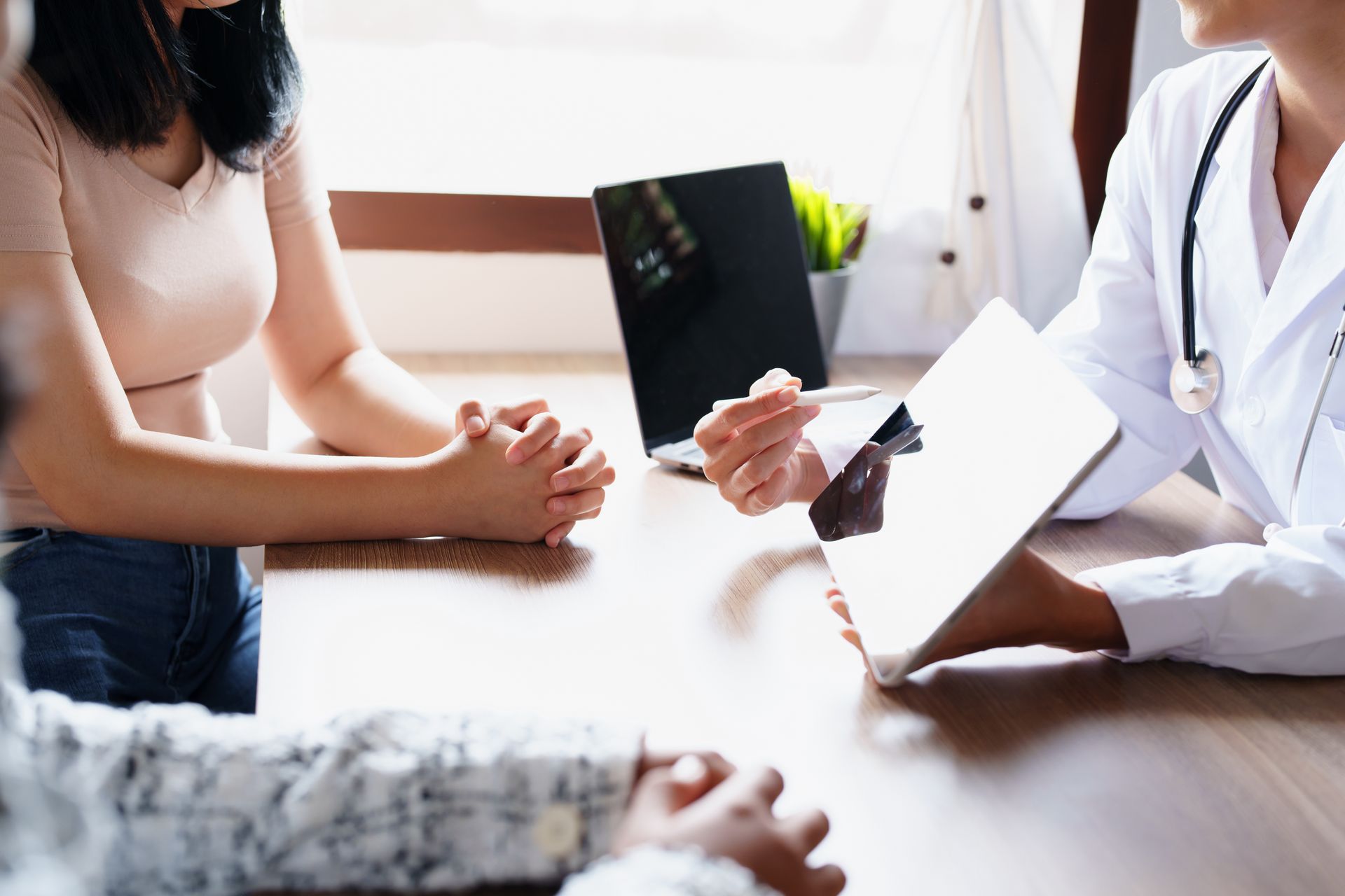 A doctor holding a tablet and advising clients on regenerative health issues