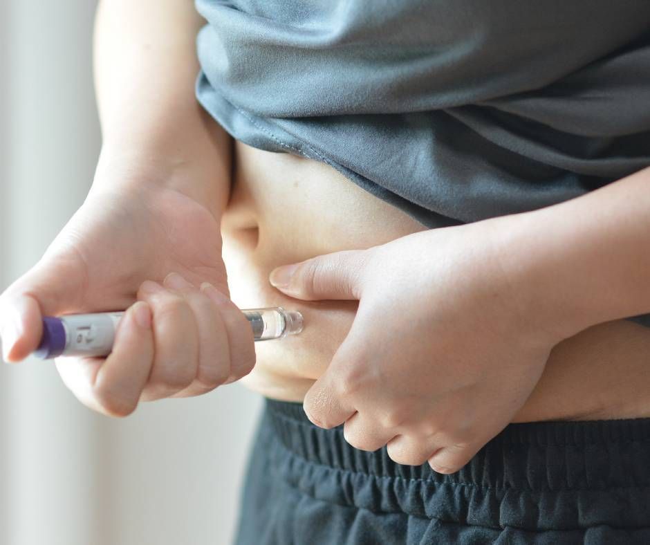 A patient injecting themselves with a GLP-1 prescription at home