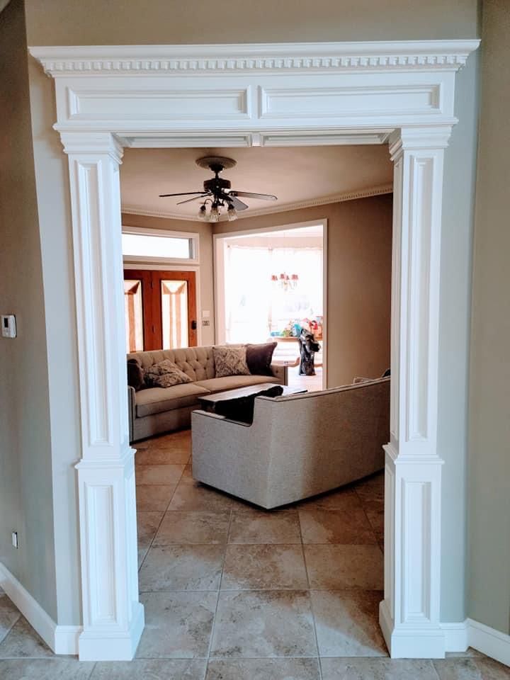 A living room with a couch , table , and ceiling fan.