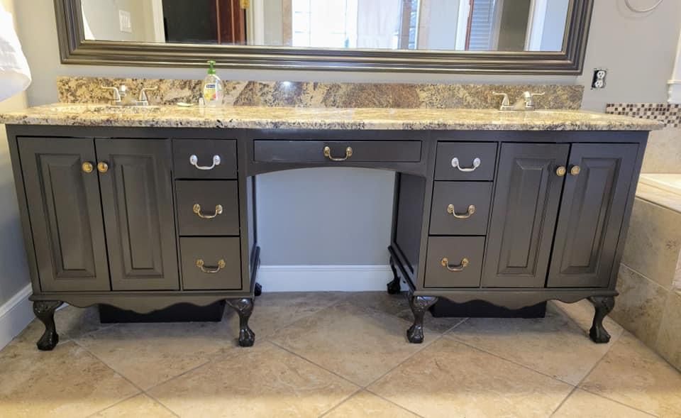 A bathroom vanity with two sinks and a mirror.