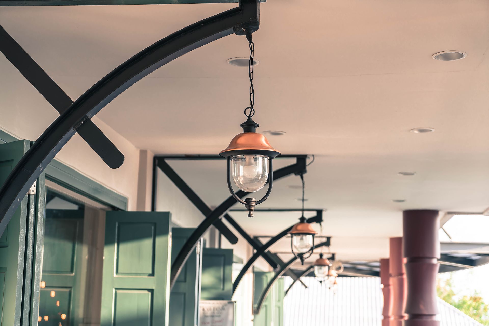A row of street lights hanging from the ceiling of a building.