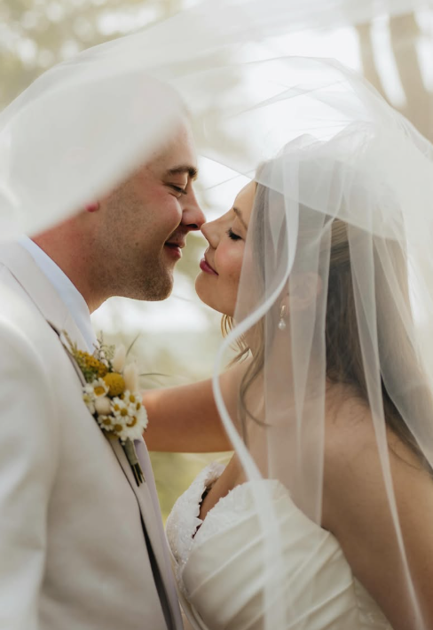 A woman in a wedding dress with a veil