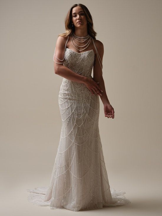 A woman is wearing a wedding dress and a pearl necklace.