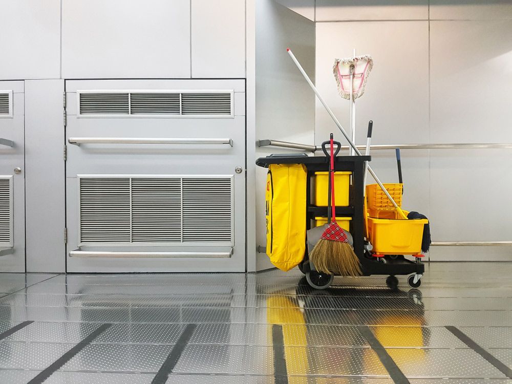 A cleaning cart with a mop , broom and bucket in a room. — O & D House Wash & Cleaning Services in Pittsworth, QLD