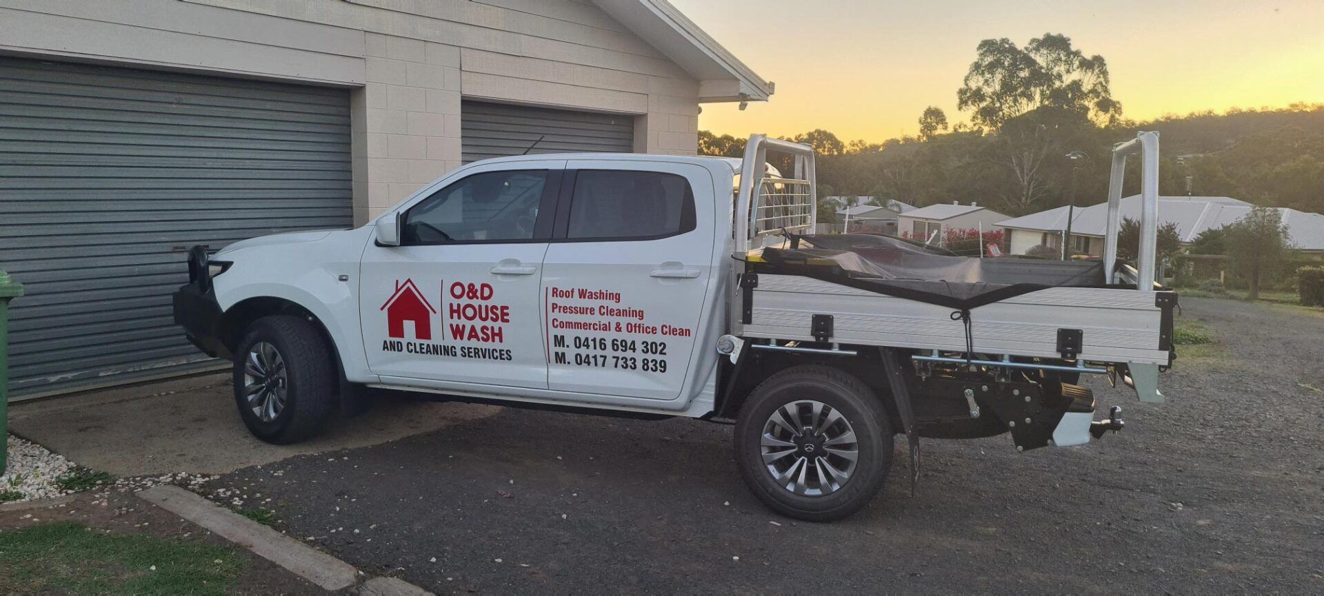 A Truck is Parked in Front of a Garage Door — O & D House Wash & Cleaning Services in Glenvale, QLD