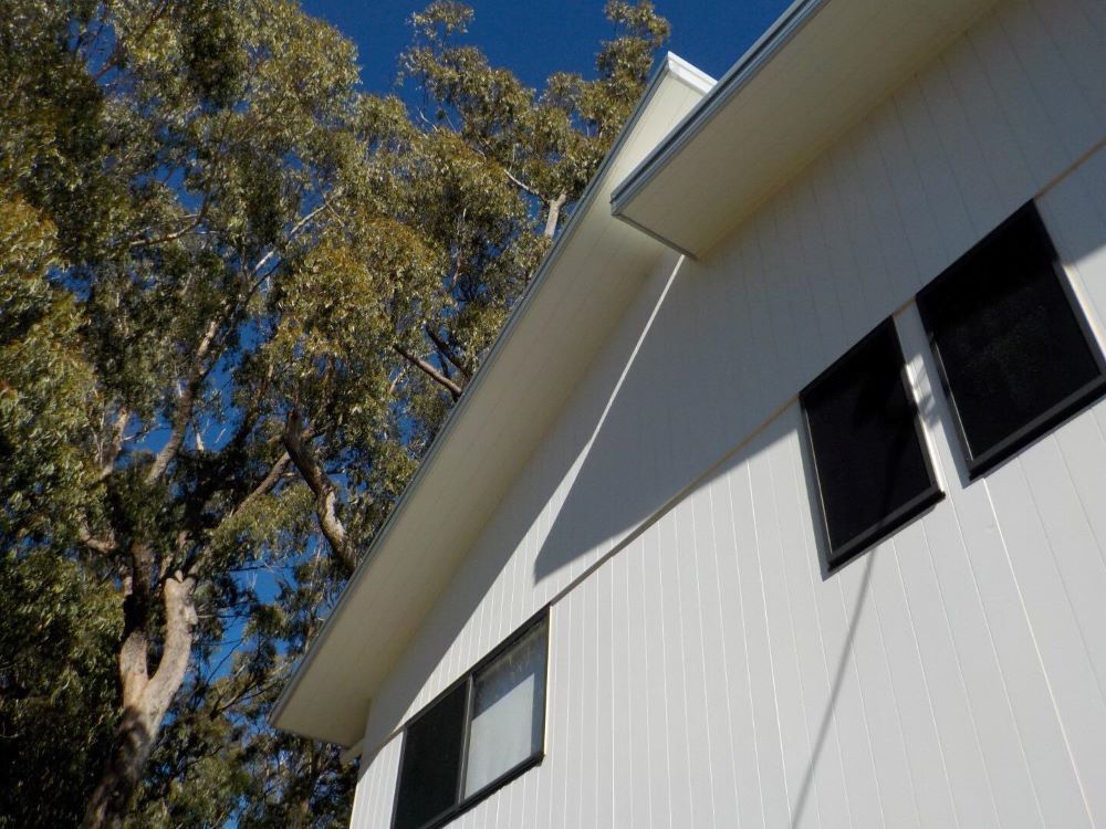 A House With Black Windows and a Tree — O & D House Wash & Cleaning Services in Glenvale, QLD