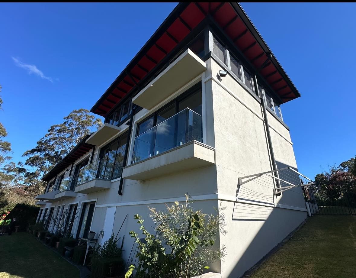 A Large House With a Red Roof and Balconies — O & D House Wash & Cleaning Services in Cambooya, QLD