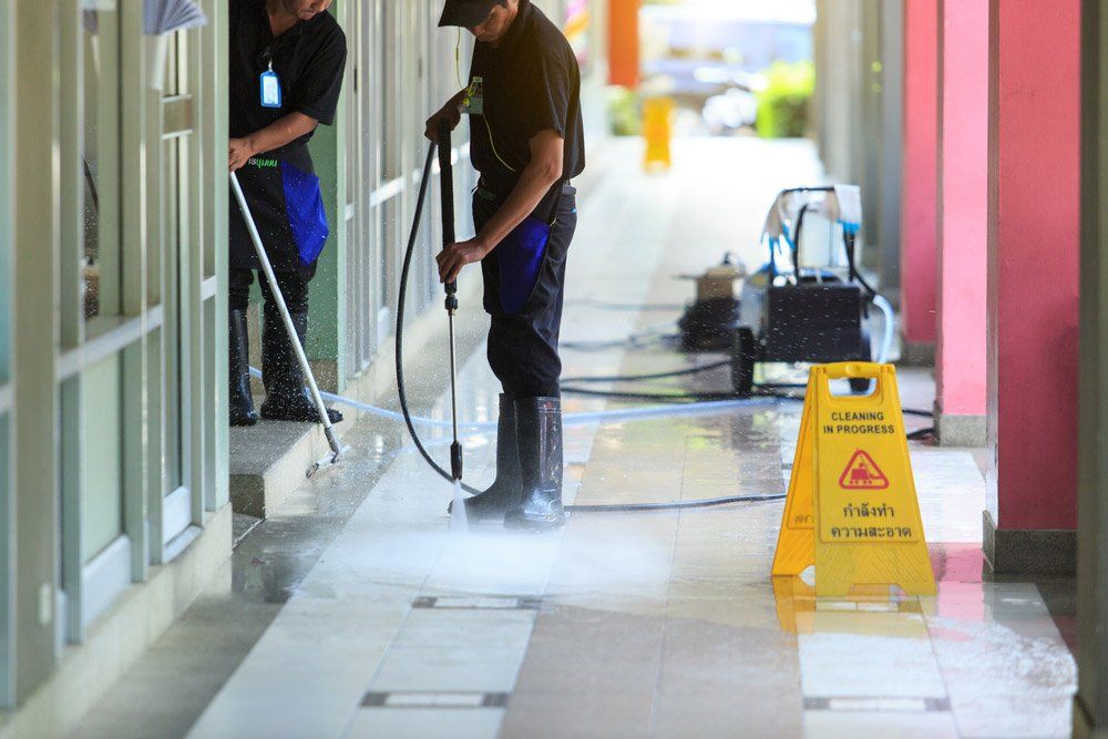 Two Man Workers Cleaning The Ground Floor — O & D House Wash & Cleaning Services in Glenvale, QLD