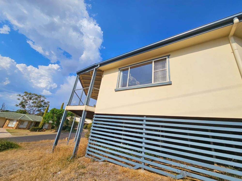 A House With a Blue Fence — O & D House Wash & Cleaning Services in Glenvale, QLD