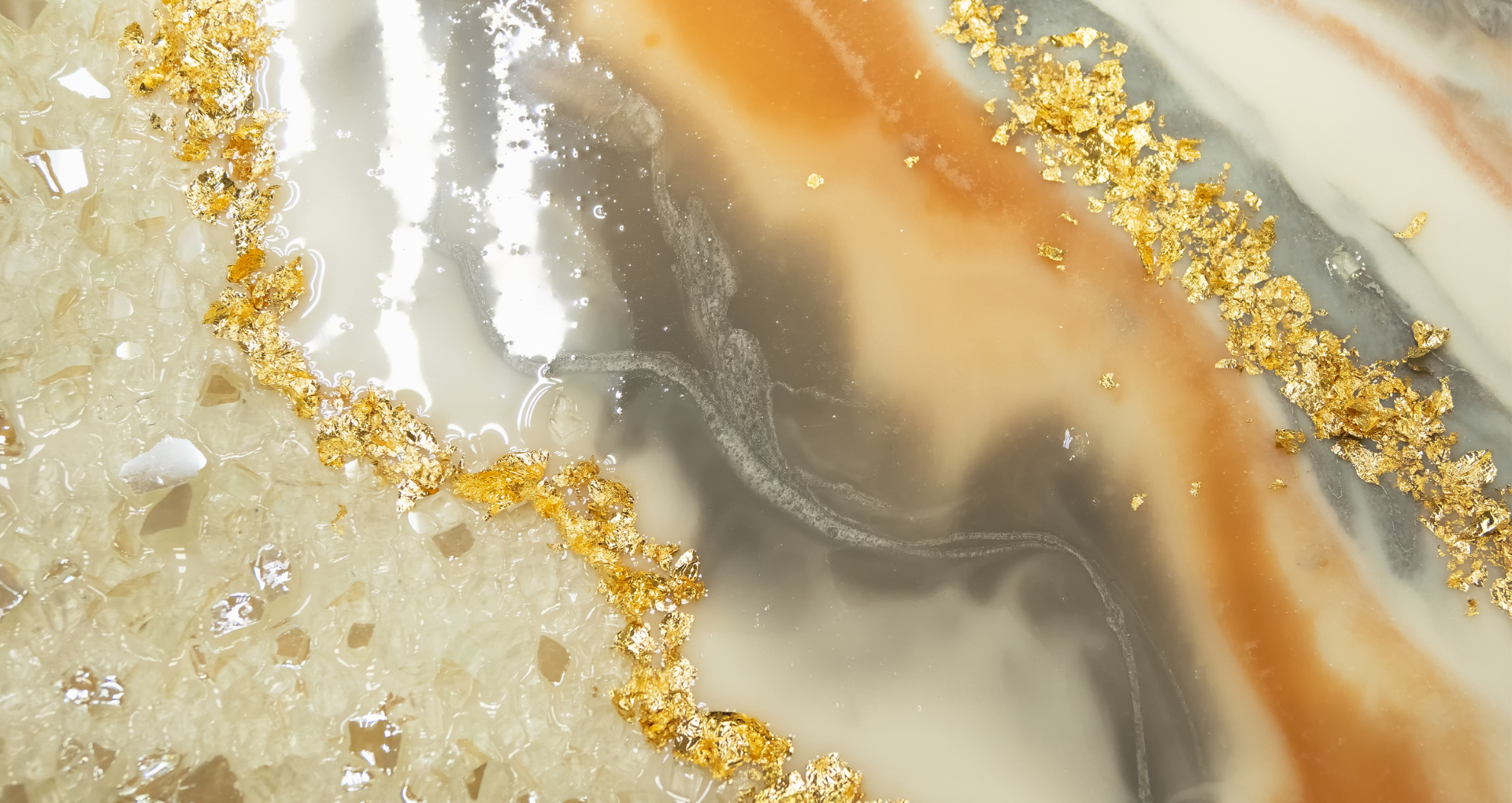 Abstract beige, gray, and white marble with gold glitter veins