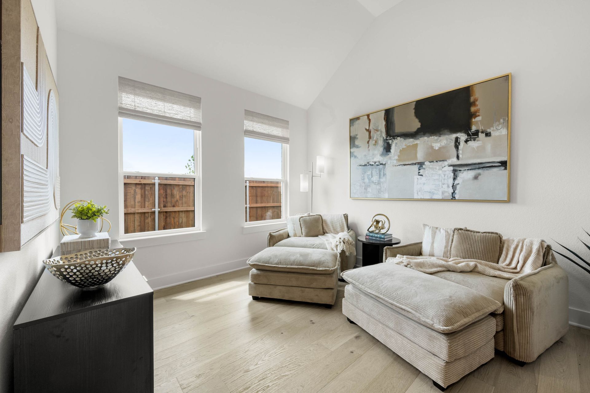 Virtual Tours | View Tours | Picture of Private living room with two chaise lounges, large abstract art, and windows.