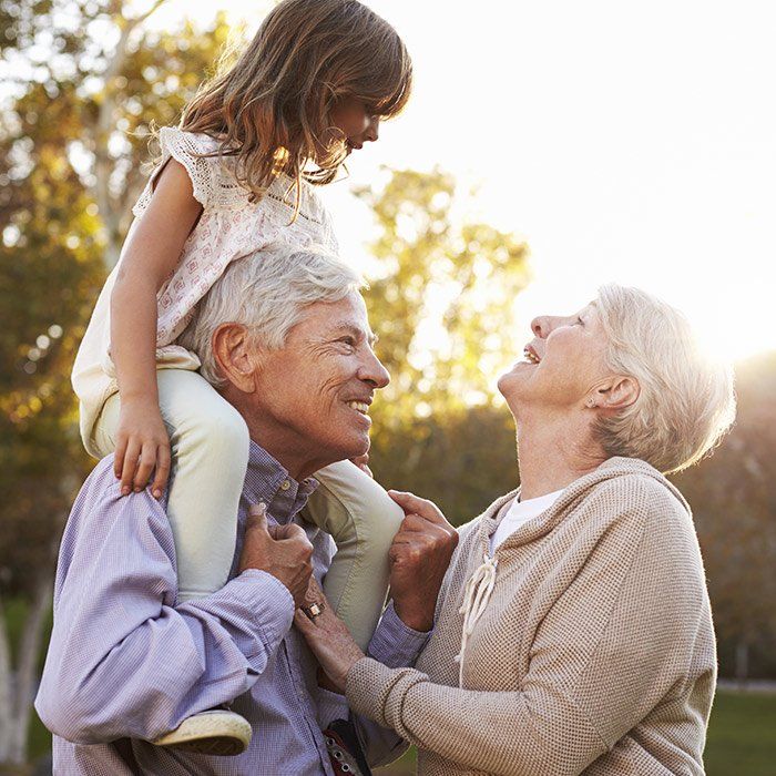 Grandparents Playing With Their Granddaughter