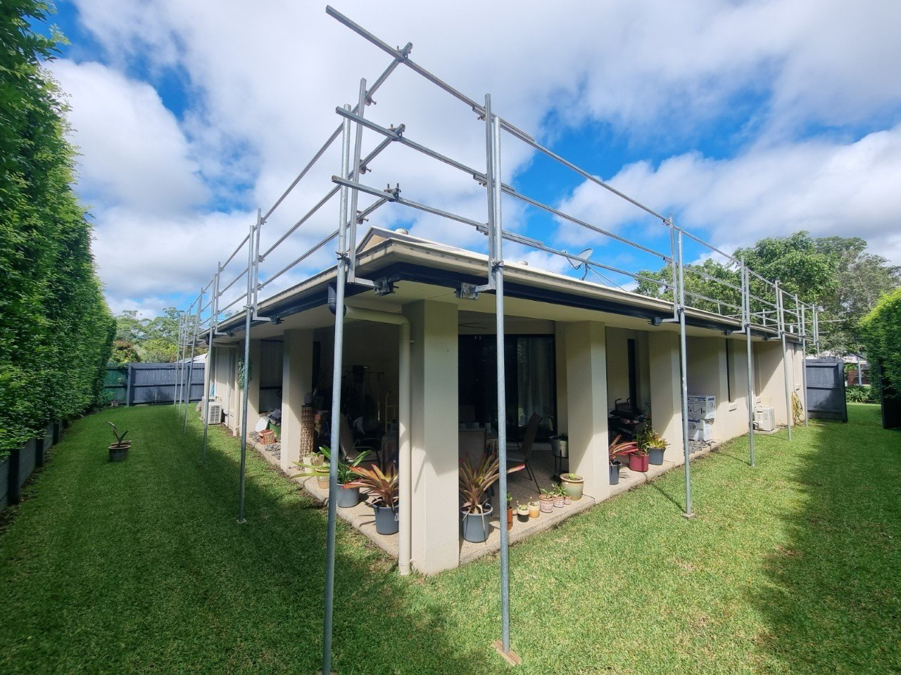 A house with scaffolding on the side of it.