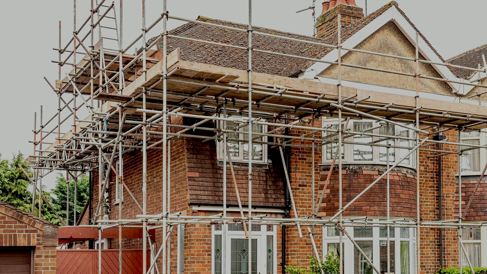 Brick house with scaffolding for construction or repairs.