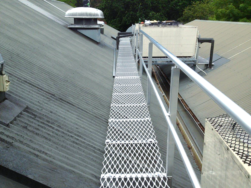 A metal walkway leading to the roof of a building.