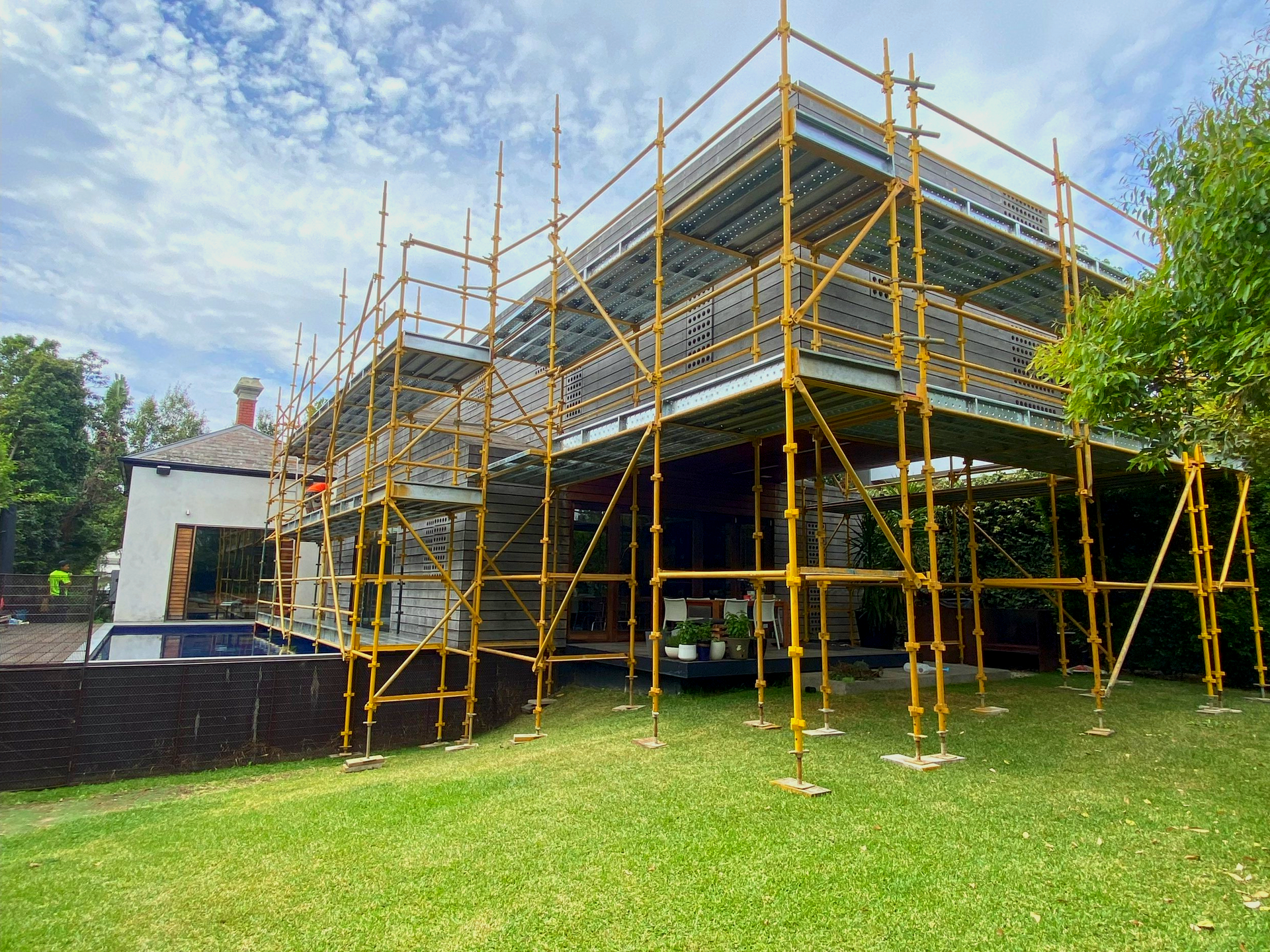 A residential building is being built with scaffolding around it.