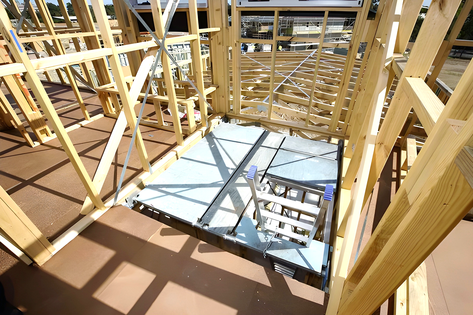The inside of a building under construction with wooden beams.
