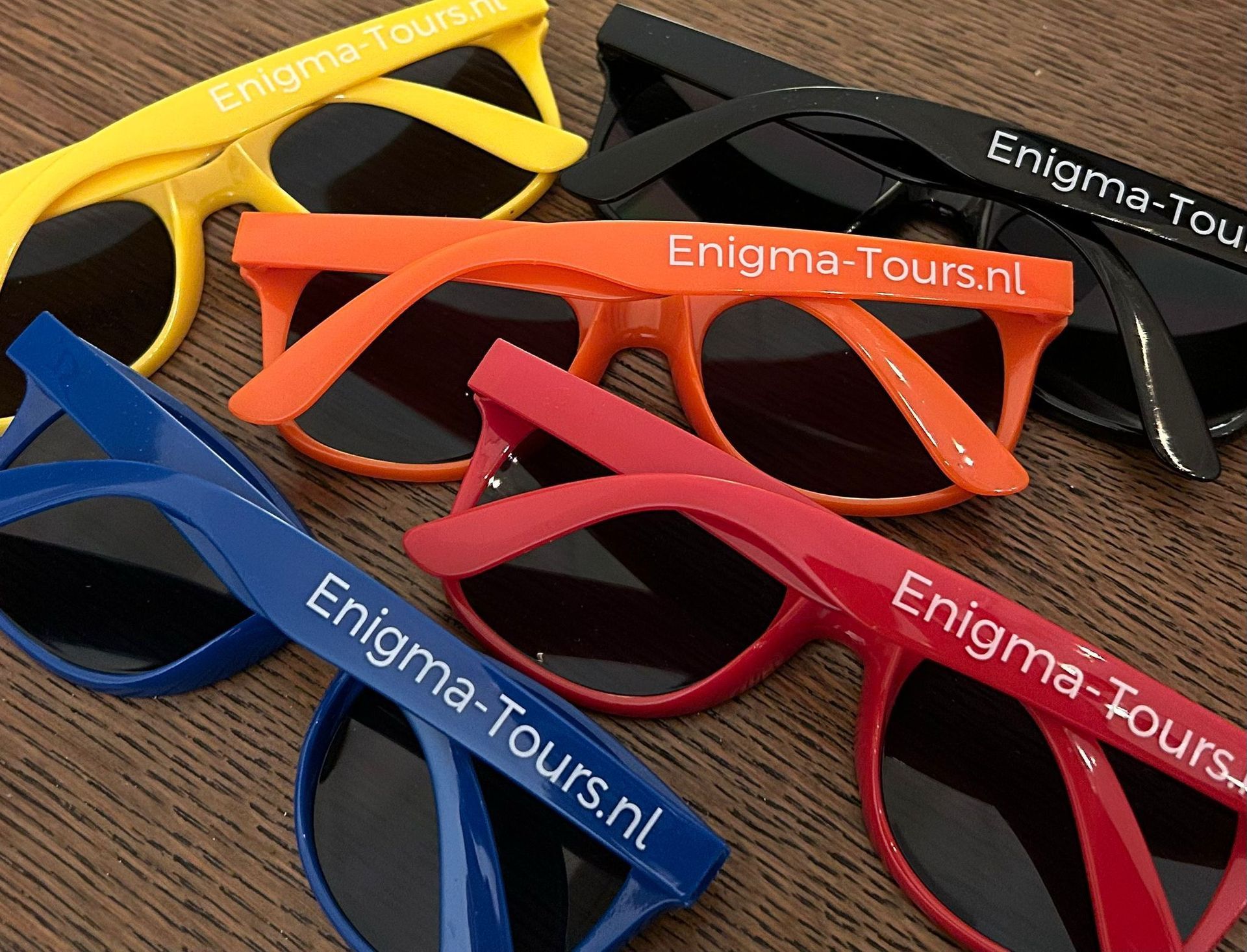 Zonnebrillen in diverse kleuren (geel, zwart, oranje, blauw, rood) met