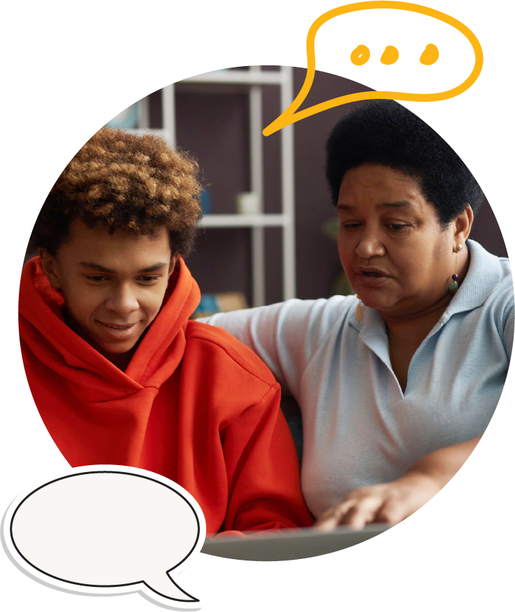 A woman and her teenage son are talking and looking at the teen's laptop.