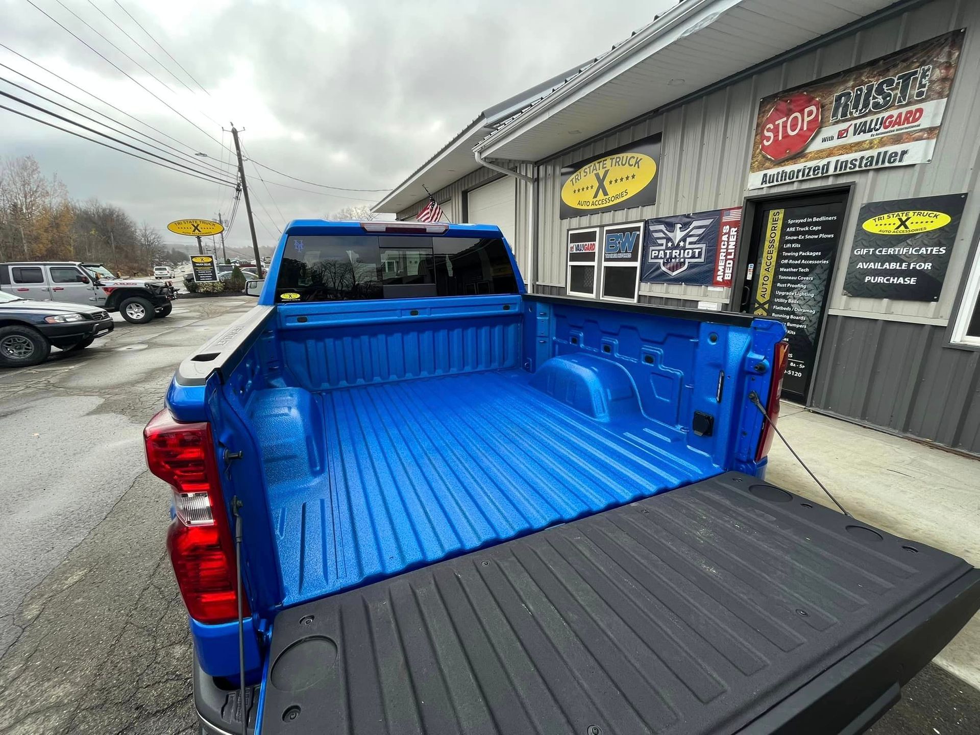 blue truck in front of a building.