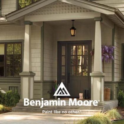 Benjamin Moore logo over a house porch with a front door and hanging lantern