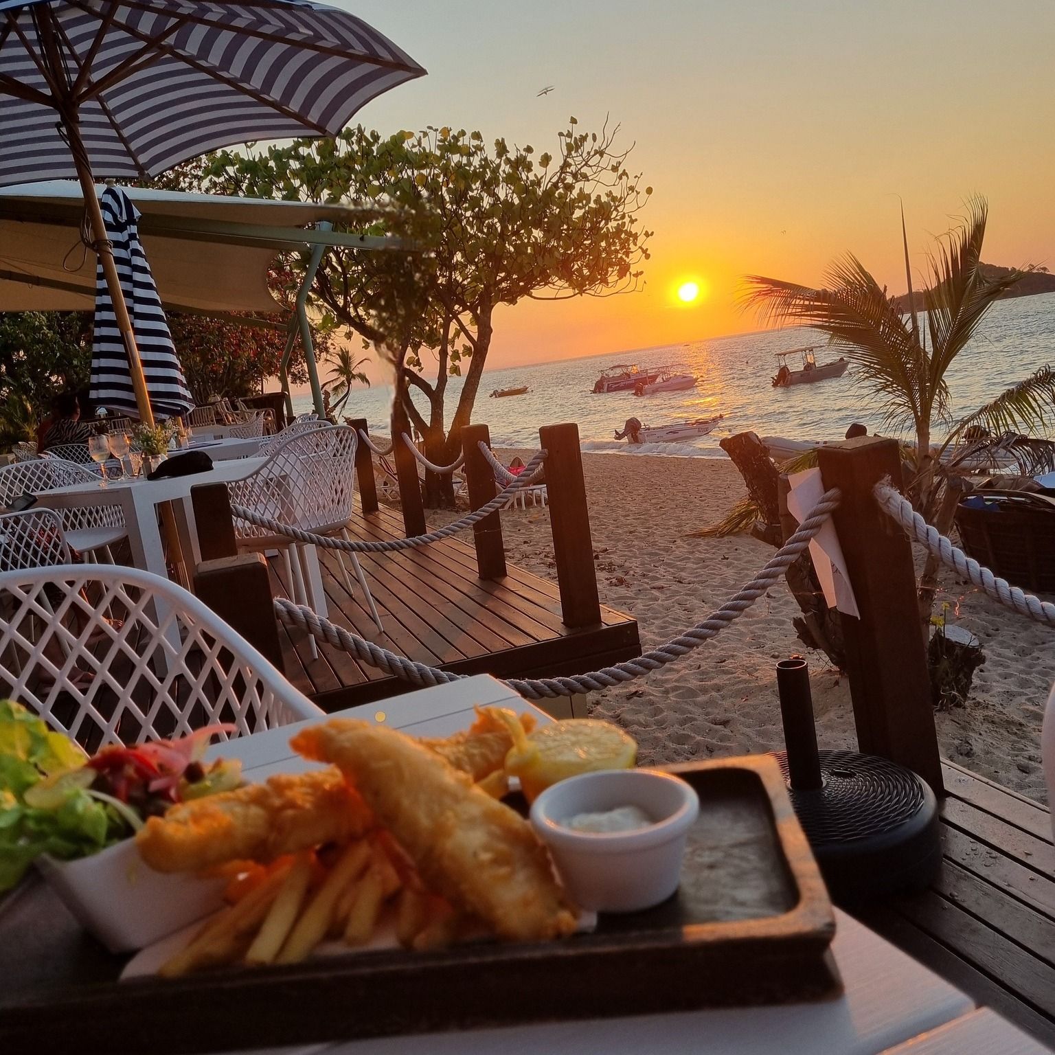 Fish and chips meal on a wooden tray — The Beach Bar and Restaurant at Montes in Cape Gloucester, QLD