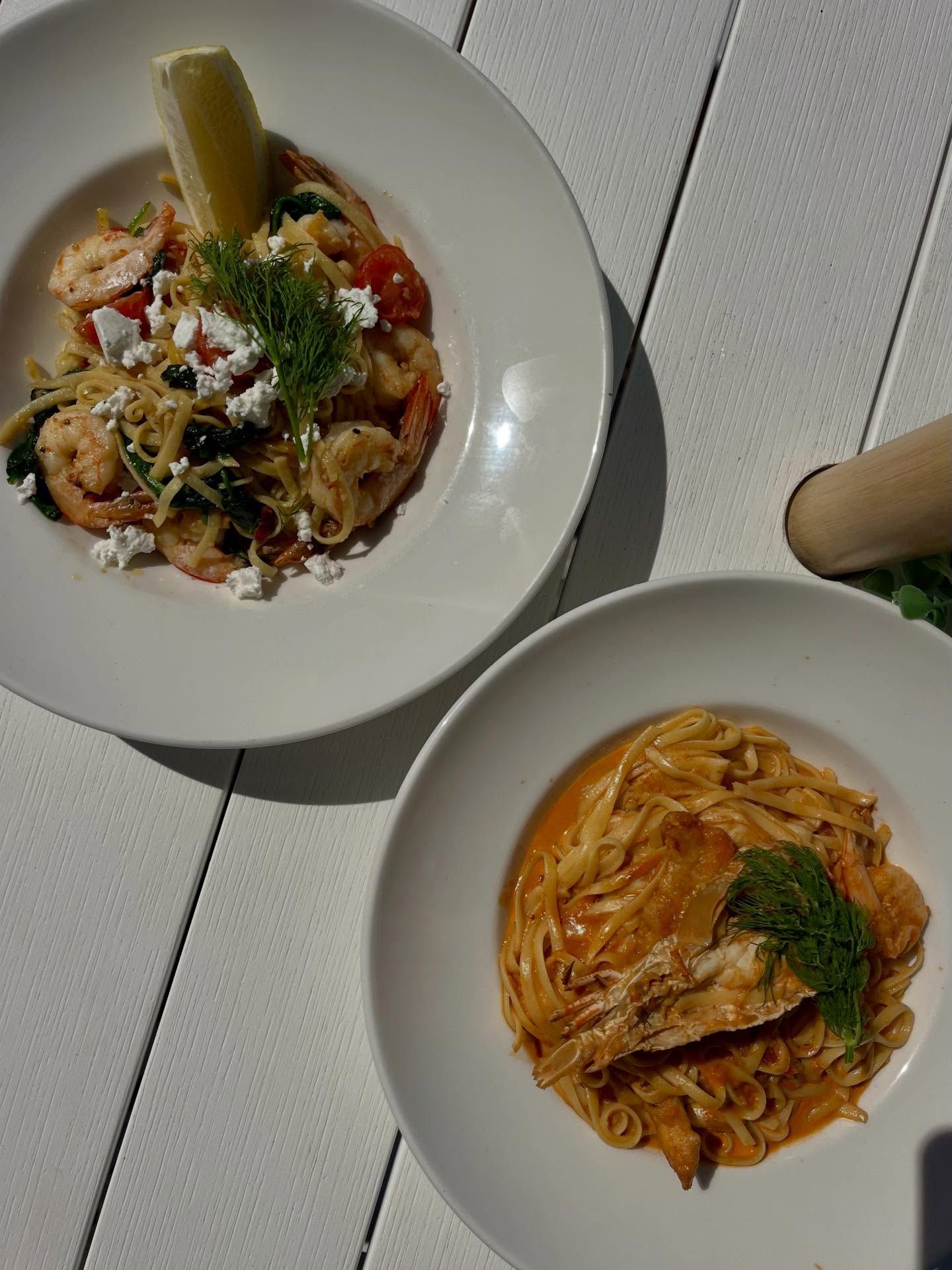 Two plates of pasta on a white table — The Beach Bar and Restaurant at Montes in Cape Gloucester, QLD