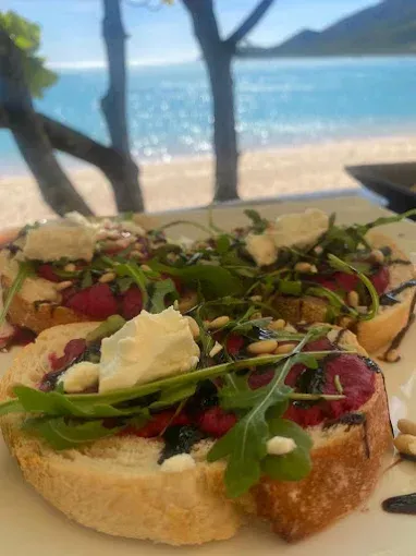 Bruschetta with arugula, goat cheese, and balsamic glaze — The Beach Bar and Restaurant at Montes in Cape Gloucester, QLD
