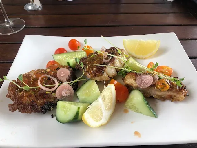Pan-seared fish with cucumber, tomato, shallots, and lemon — The Beach Bar and Restaurant at Montes in Cape Gloucester, QLD