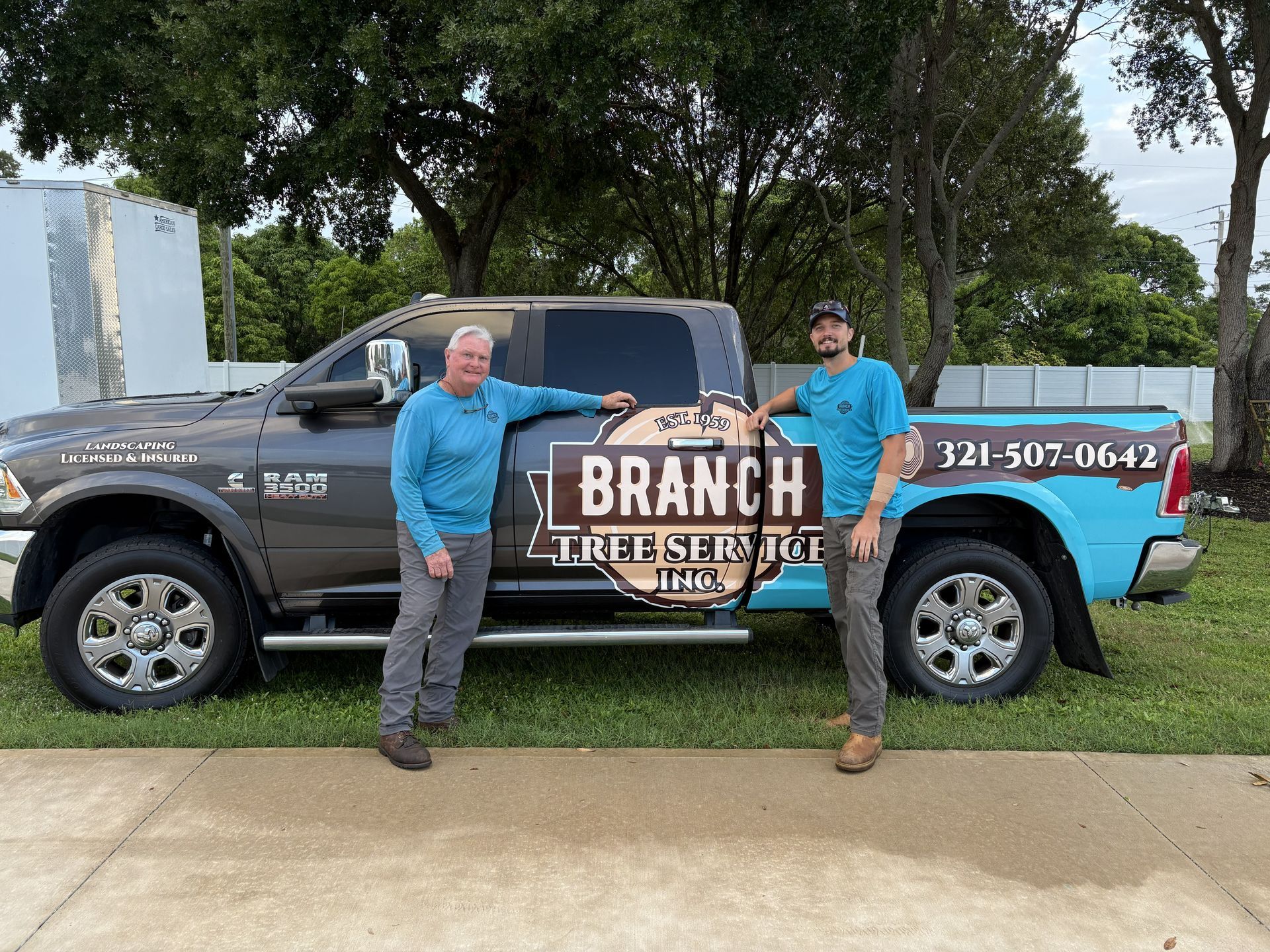 Two men stand by a truck with