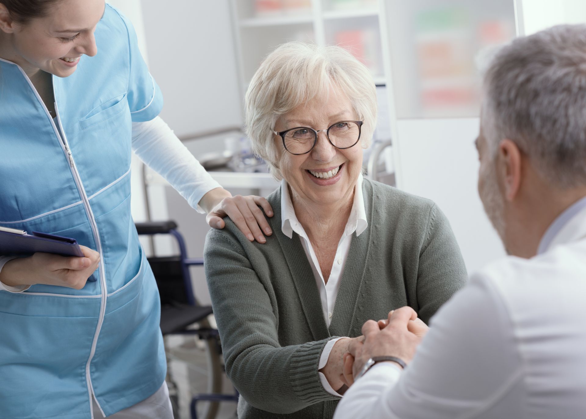 Doctor and senior patient shaking hands in the office
